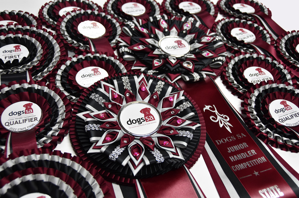 Bespoke rosette with petals, curls, braiding, diamantes, embroidery and a custom bezelled button.