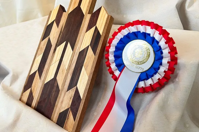 RB300-70 box pleated three tier rosette in blue, white and red.